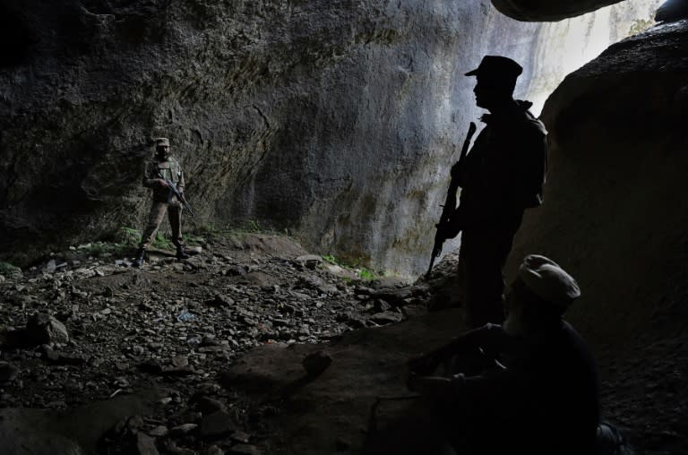 Pakistani soldiers stand guard at the site of the seventh-century Buddha of Swat