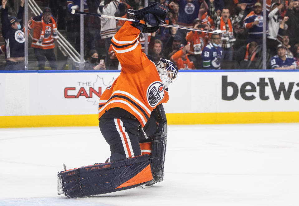 Edmonton Oilers goalie Mike Smith celebrates the team's shootout win over the Vancouver Canucks in an NHL hockey game Wednesday, Oct. 13, 2021, in Edmonton, Alberta. (Jason Franson/The Canadian Press via AP)
