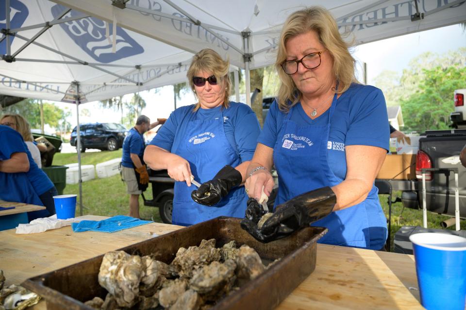 Ladies from United Southern Bank shuck oysters at Beast Feast on Oct. 24, 2019.