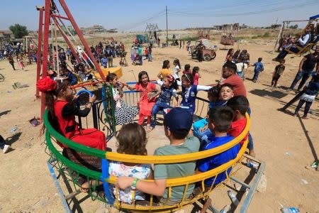 Iraqi children play as they celebrate Eid al-Fitr, in Mosul, Iraq June 25, 2017. REUTERS/Alaa Al-Marjani