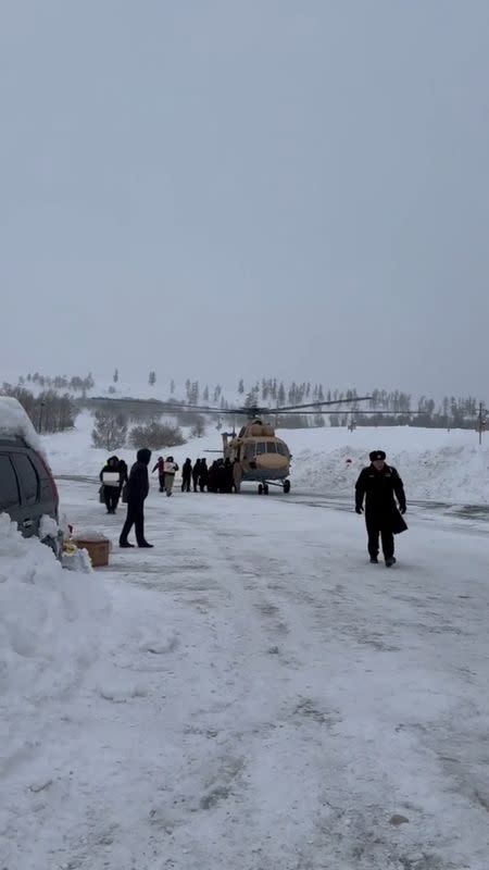 Tourists stranded by avalanches lifted to safety by helicopter, in Burqin County