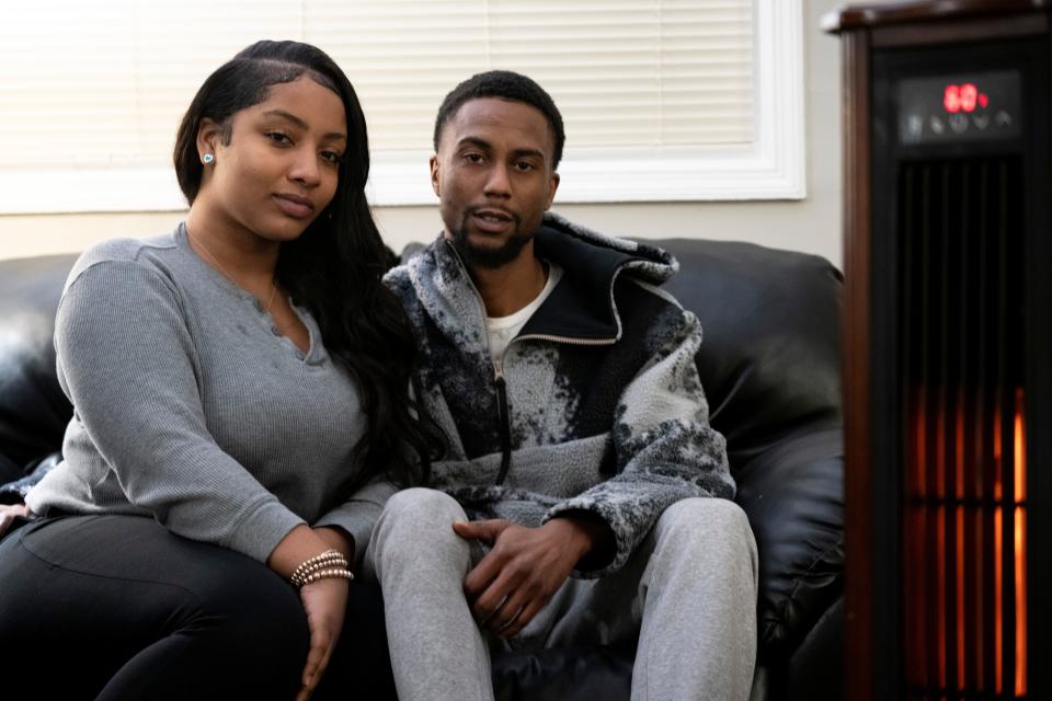 Journi Boone and Landon Pickett sit on the couch of their East Price Hill home on Jan. 6. It was 50 degrees in their home, where the furnace blew cold air instead of heat.