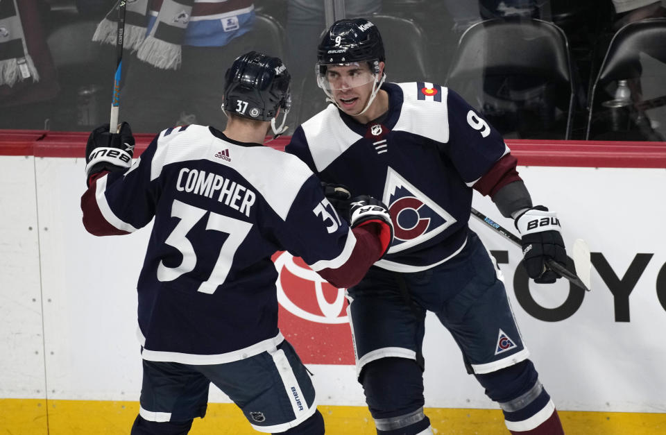 Colorado Avalanche left wing J.T. Compher, left, congratulates center Evan Rodrigues after Rodrigues scored the go-ahead goal in the third period of an NHL hockey game against the Winnipeg Jets, Thursday, April 13, 2023, in Denver. (AP Photo/David Zalubowski)