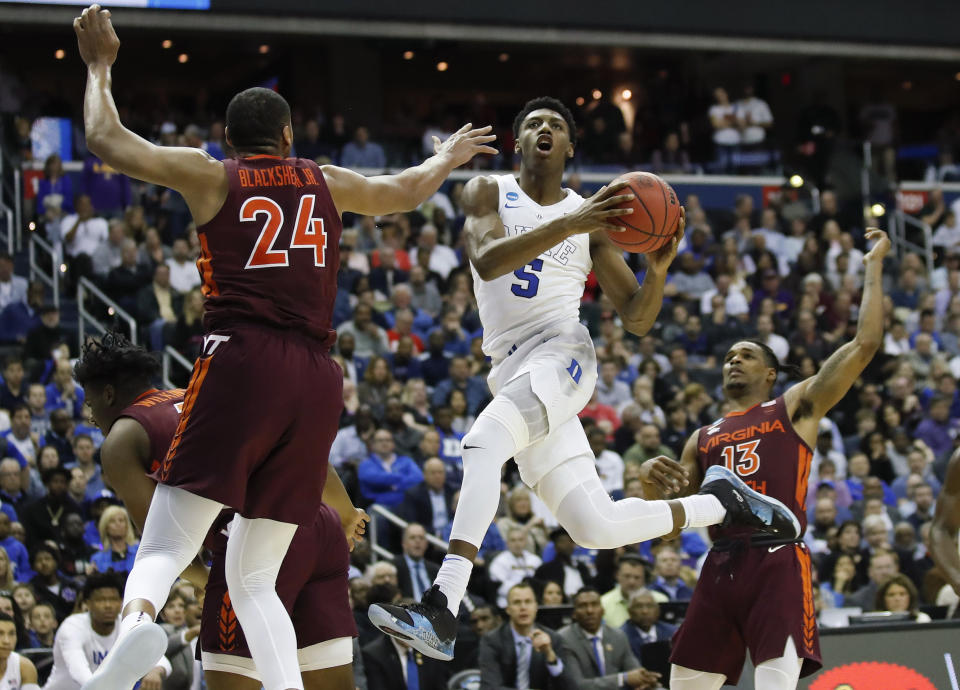 FILE - In this March 29, 2019, file photo, Duke forward RJ Barrett (5), from Canada, drives to the basket past Virginia Tech forward Kerry Blackshear Jr. (24) and guard Ahmed Hill (13) during the second half of an NCAA men's East Regional semifinal college basketball game, in Washington. The NBA Draft is an event that has had an international flavor for years. (AP Photo/Alex Brandon, File)