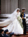 <p>Diana’s wow-factor dress was created by design duo David and Elizabeth Emanuel. It featured 275 yards of pearl-studded silk taffeta, tulle and netting – not to mention big sleeves. <em>[Photo: PA]</em> </p>