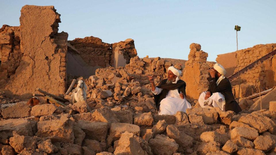 PHOTO: Afghan residents sit at a damaged house after earthquake in Sarbuland village of Zendeh Jan, district of Herat province, Afghanistan, on Oct. 7, 2023. (Mohsen Karimi/AFP via Getty Images)