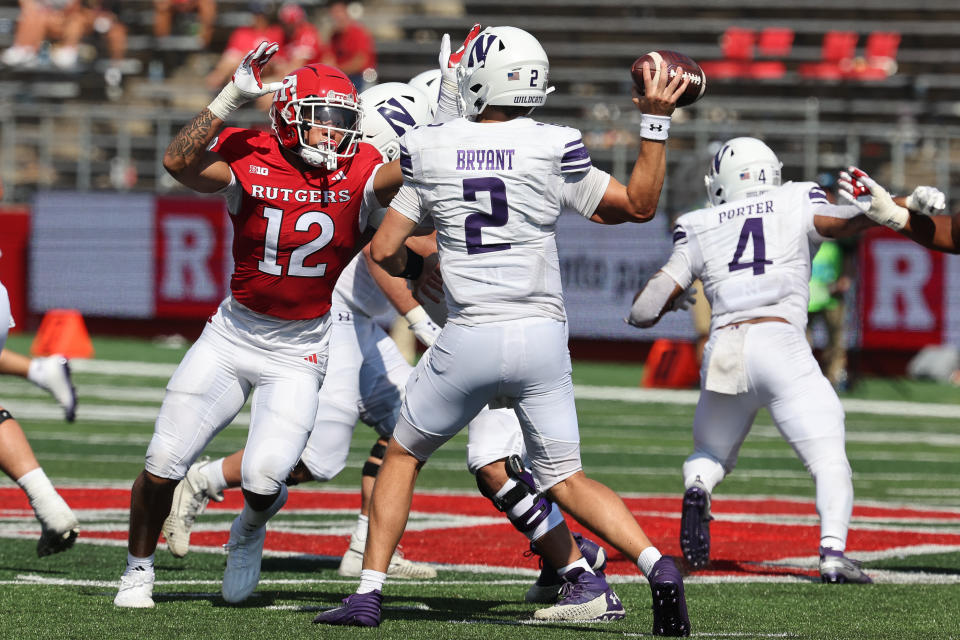 Sep 3, 2023; Piscataway, New Jersey, USA; Northwestern Wildcats quarterback Ben Bryant (2) throws the ball as Rutgers Scarlet Knights defensive lineman Kenny Fletcher (12) defends during the second half at SHI Stadium. Mandatory Credit: Vincent Carchietta-USA TODAY Sports