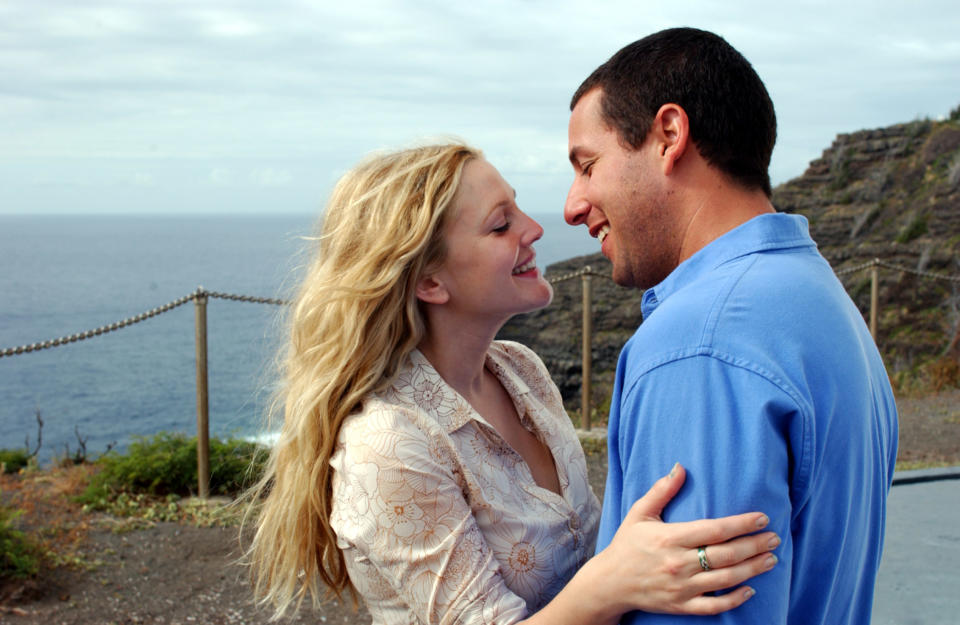 Henry and Lucy embrace by the seaside