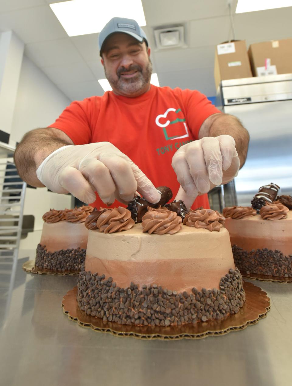 Just for added culinary delight Luca Pastry's Tony Cangialosi tops a chocolate cake with a pair of ricotta and chocolate cannoli.