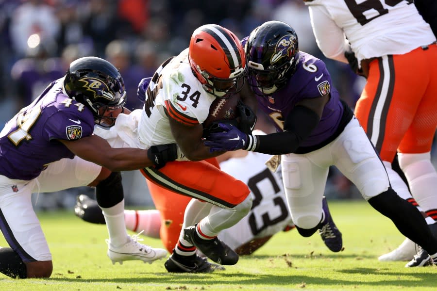 BALTIMORE, MARYLAND – NOVEMBER 12: Jerome Ford #34 of the Cleveland Browns is tackled by Marlon Humphrey #44 of the Baltimore Ravens and Patrick Queen #6 during the first quarter at M&T Bank Stadium on November 12, 2023 in Baltimore, Maryland. (Photo by Scott Taetsch/Getty Images)