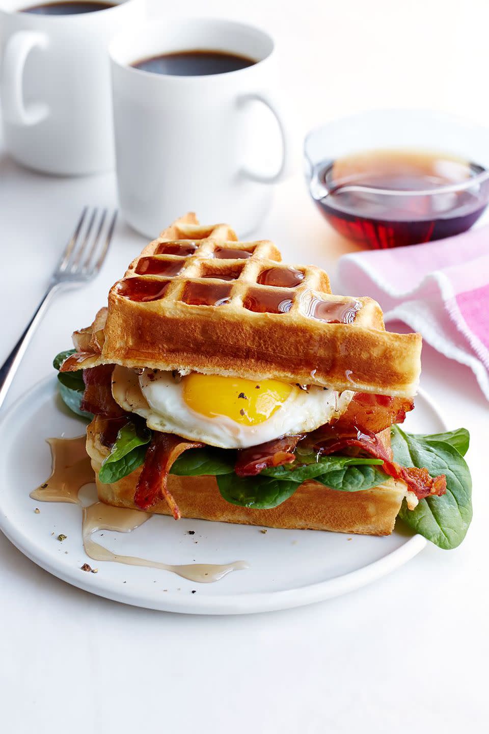 breakfast in bed buttermilk waffle bacon and egg sandwich