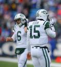 Tim Tebow #15 of the New York Jets walks off the field as Mark Sanchez #6 walks on against the Buffalo Bills at Ralph Wilson Stadium on December 30, 2012 in Orchard Park, New York. (Photo by Rick Stewart/Getty Images)