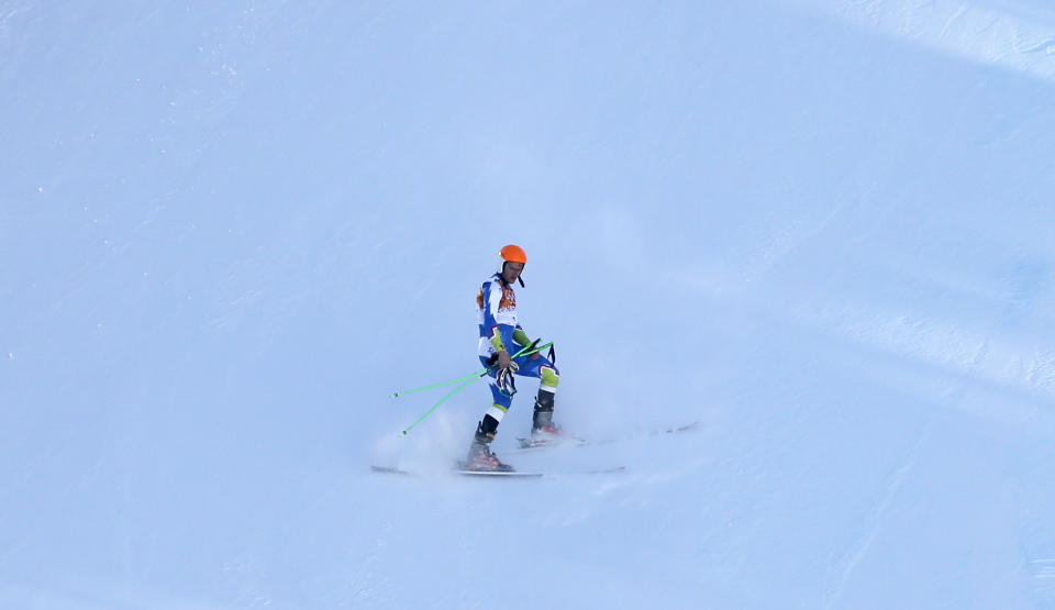 Slovenia's Rok Perko comes to a halt in the finish area after crashing during a men's downhill training run for the Sochi 2014 Winter Olympics, Saturday, Feb. 8, 2014, in Krasnaya Polyana, Russia. (AP Photo/Christophe Ena)