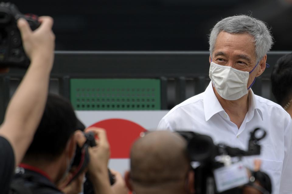 Singapore's Prime Minister and secretary-general of the ruling People's Action Party Lee Hsien Loong looks at members of the media as he prepares to leave after voting in the general election in Singapore on July 10, 2020. (Photo by ROSLAN RAHMAN / AFP) (Photo by ROSLAN RAHMAN/AFP via Getty Images)