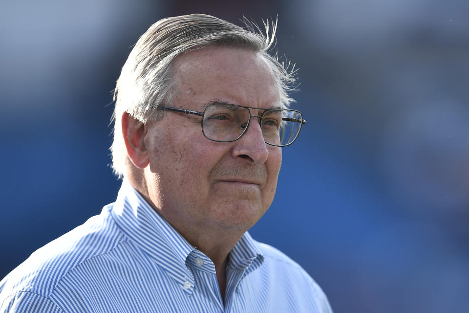 FILE - In this Aug. 8, 2019, file photo, Terry Pegula, owner of the Buffalo Bills, walks on the field before an NFL preseason football game against the Indianapolis Colts in Orchard Park, N.Y. The Bills have informed county officials they will not use an early and one-time opt-out clause to terminate their lease at New Era Field. The team's decision, sent in a letter to Erie County Executive Mark Poloncarz on Friday, Jan. 31, 2020, was considered a formality, but in no way rules out the possibility of the Bills one day playing at new facility in downtown Buffalo. (AP Photo/Adrian Kraus, File)