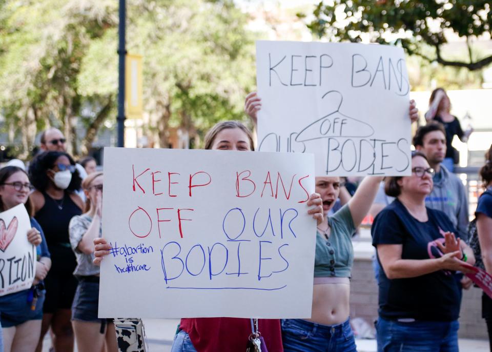 Protestors gather and hold up signs at the "Save Roe" protest at Judge Stephan P. Mickle, Sr. Criminal Court House on May 3, 2022. [Gabriella Whisler/Special to the Sun]