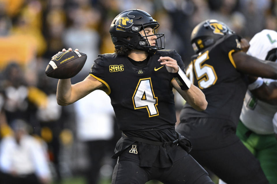 Appalachian State quarterback Joey Aguilar drops back to pass during the first half of the team's NCAA college football game against Marshall on Saturday, Nov. 4, 2023, in Boone, N.C. (AP Photo/Matt Kelley)