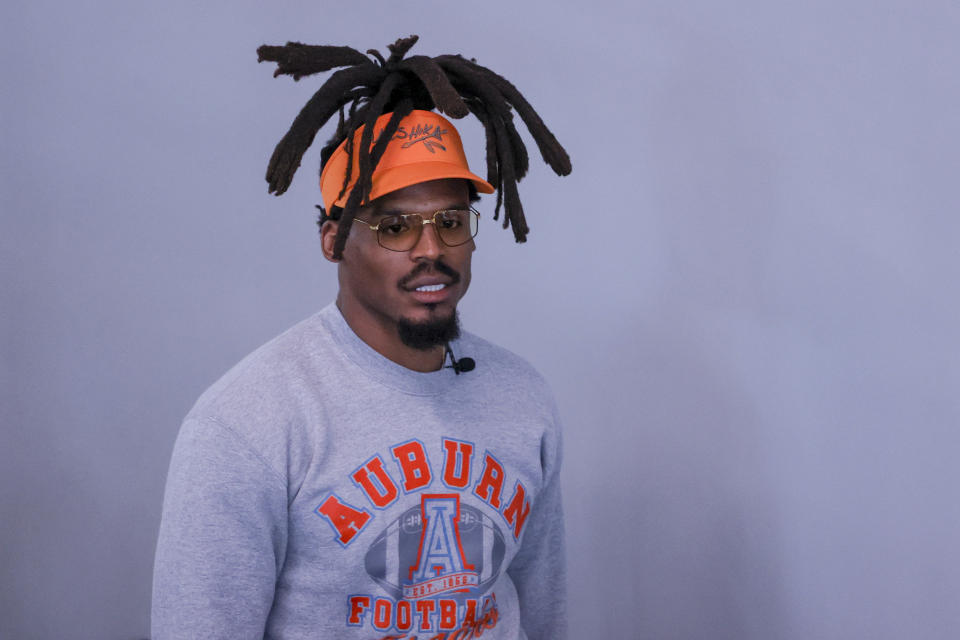 Former NFL and Auburn quarterback, Cam Newton, walks into the weight room during Auburn Pro Day, Tuesday, March 21, 2023, in Auburn, Ala. (AP Photo/Butch Dill)