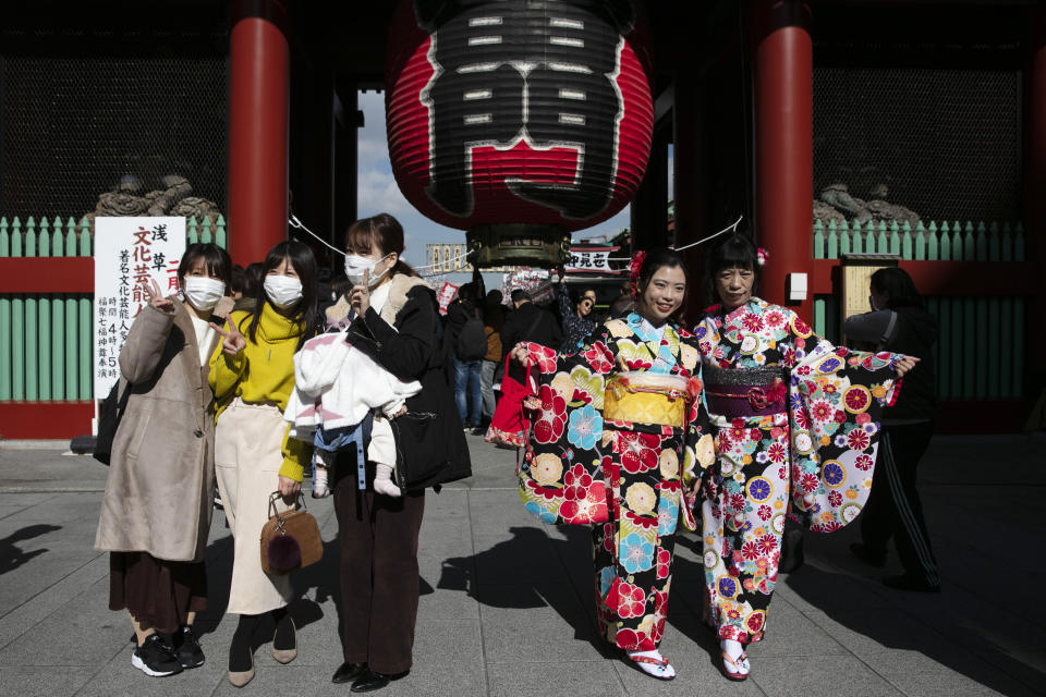 FILE - Tourists pose for photos at the entrance to Sensoji Temple on Jan. 30, 2020, in Tokyo. Individual travelers will be able to visit Japan without visas beginning Tuesday, Oct. 11, just like in pre-COVID-19 times. (AP Photo/Jae C. Hong, File)