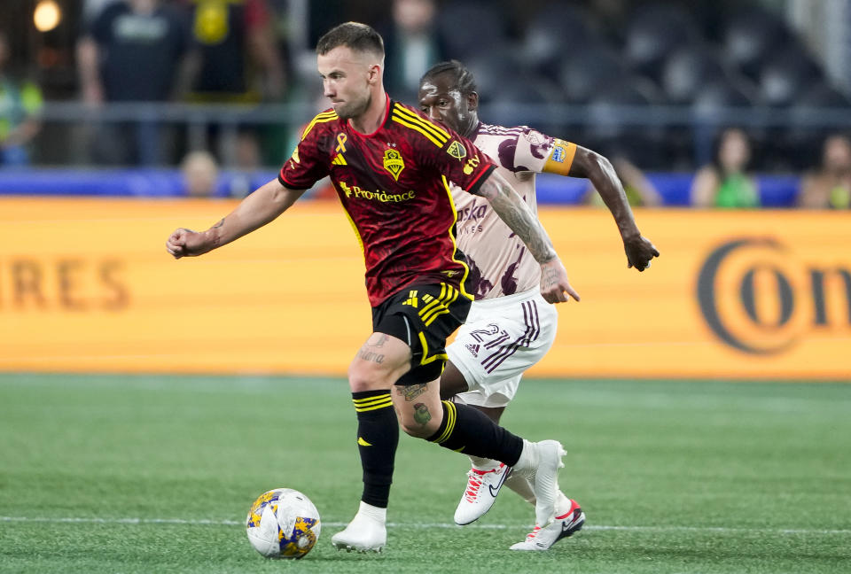 Seattle Sounders midfielder Albert Rusnák drives the ball against Portland Timbers midfielder Diego Chará (21) during the first half of an MLS soccer match Saturday, Sept. 2, 2023, in Seattle. (AP Photo/Lindsey Wasson)