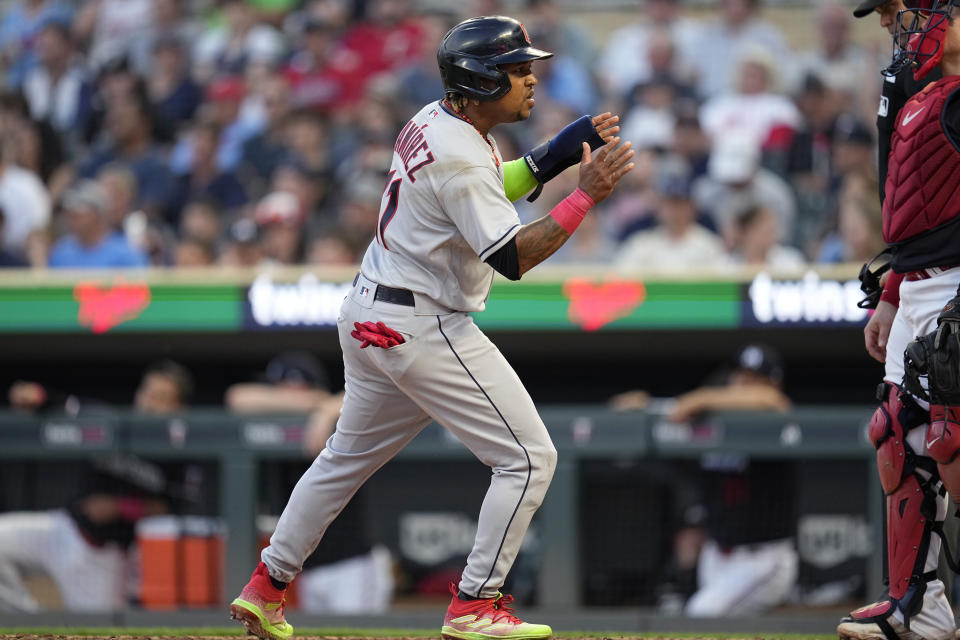 Cleveland Guardians' Jose Ramirez, left, celebrates after scoring during the sixth inning of a baseball game against the Minnesota Twins, Thursday, June 1, 2023, in Minneapolis. (AP Photo/Abbie Parr)