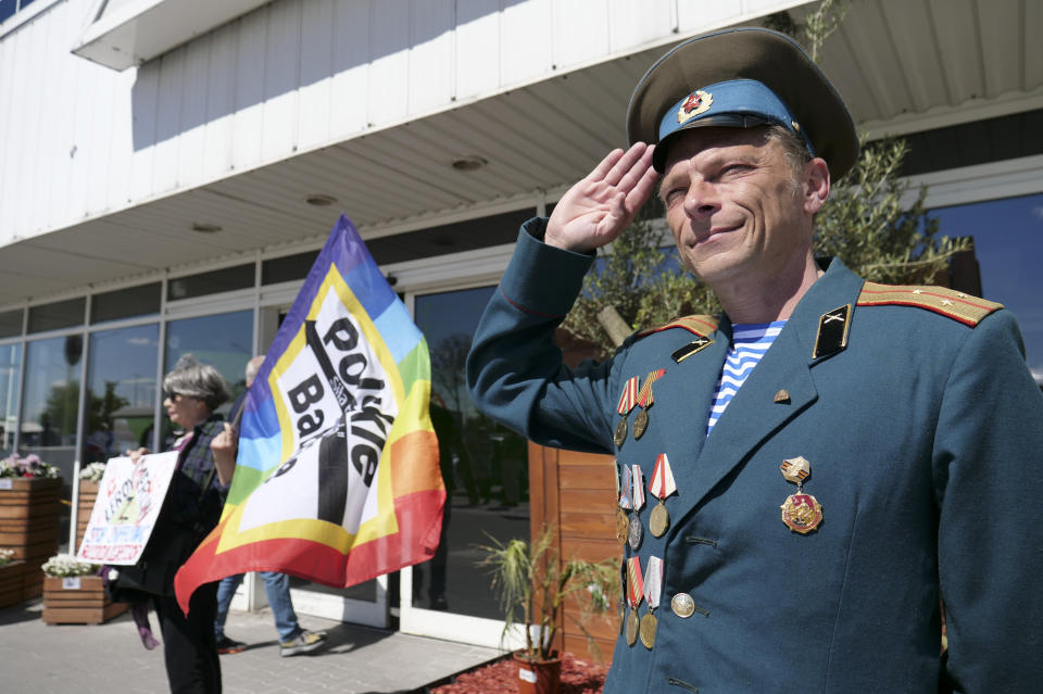 Polish activist Arkadiusz Szczurek, right, takes part in a protest outside an outlet of French home improvement retailer Leroy Merlin in Warsaw, Poland, on Saturday May 7, 2022. In the weeks after Russia invaded Ukraine, a protest movement was born in Poland urging people to boycott companies that have chosen to keep operating in Russia. (AP Photo/Pawel Kuczynski)