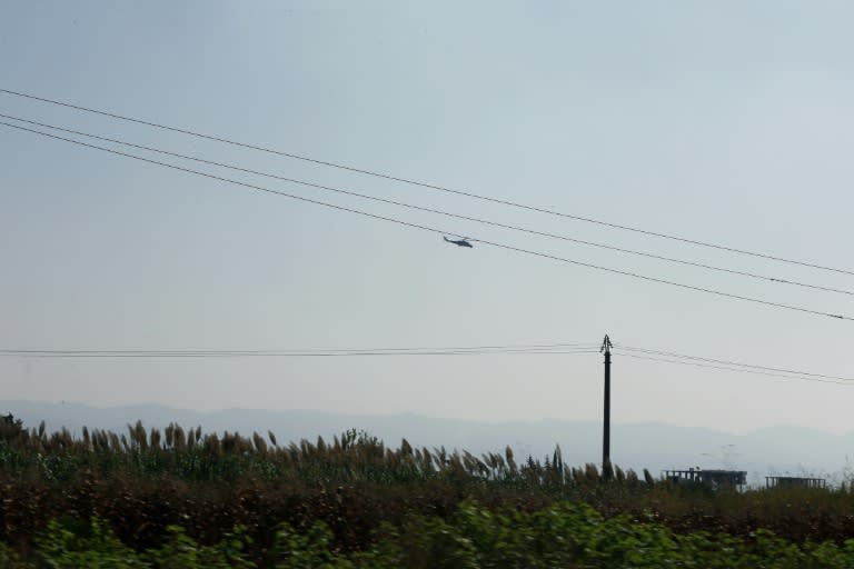 A Russian-made Mi-35 Hind attack helicopter hovers over Latakia airport in the government-controlled coastal Syrian city on September 24, 2015