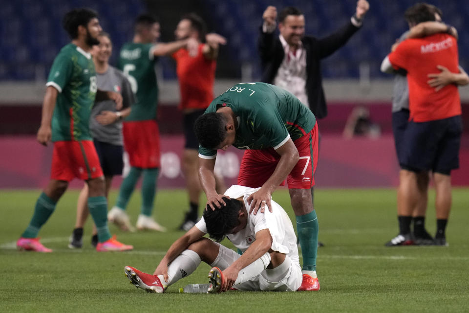 Mexico's Luis Romo, above, talks to Japan's Takefusa Kubo at the end of the men's bronze medal soccer match at the 2020 Summer Olympics, Friday, Aug. 6, 2021, in Saitama, Japan. Mexico won 3-1. (AP Photo/Gregory Bull)