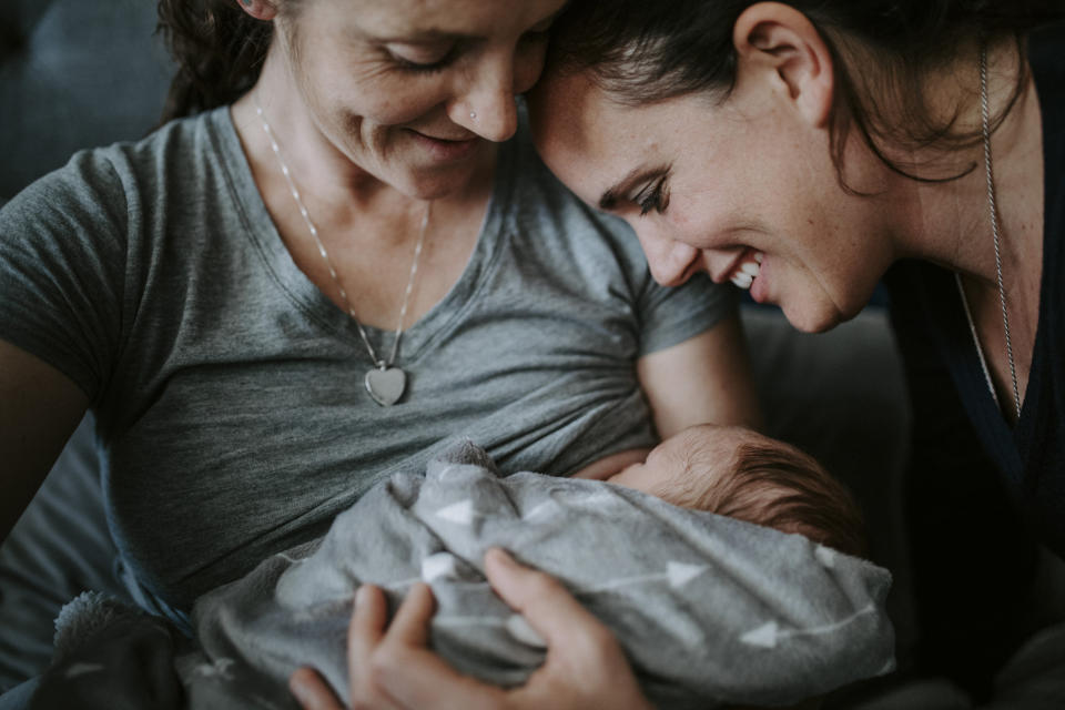 Two women with a newborn.