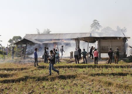 Tribal plantation workers burn houses belonging to indigenous Bodo tribesmen after ethnic clashes in Balijuri village, in Sonitpur district in the northeastern Indian state of Assam on December 24, 2014. REUTERS/Stringer