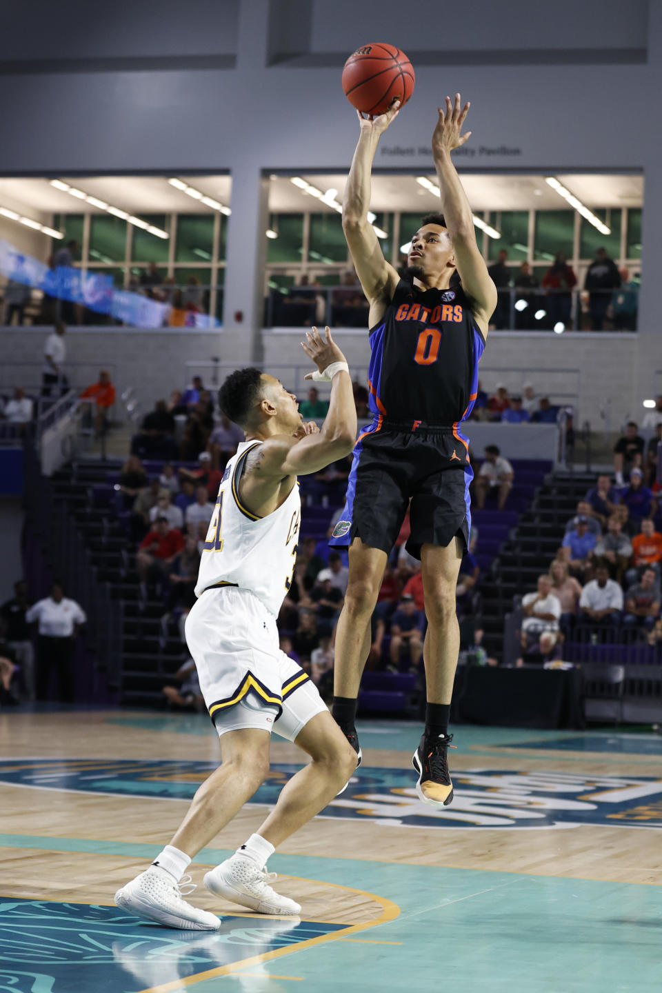 Florida guard Myreon Jones (0) shoots over California guard Jordan Shepherd (31) during the first half of an NCAA college basketball game on Monday, Nov. 22, 2021, in Fort Myers, Fla. (AP Photo/Scott Audette)