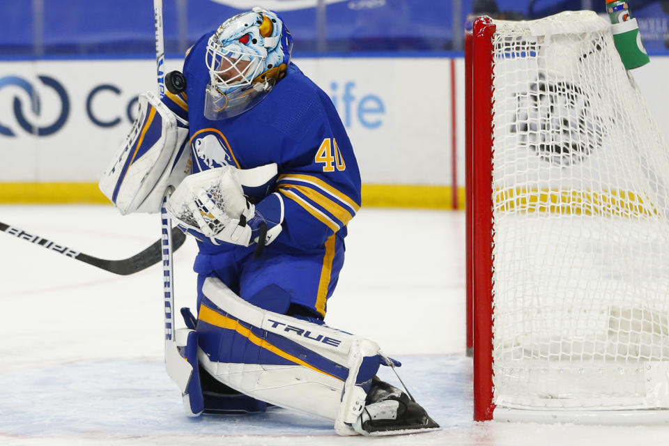 Buffalo Sabres goalie Carter Hutton (40) makes a save during the first period of an NHL hockey game against the New York Islanders, Tuesday, Feb. 16, 2021, in Buffalo, N.Y. (AP Photo/Jeffrey T. Barnes)