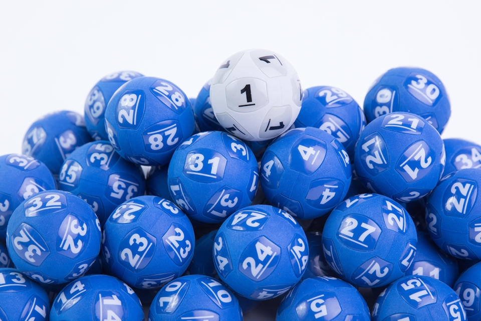 Bundle of lotto balls with a white number one Powerball on top.