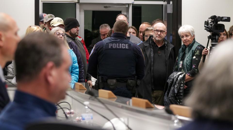 Monticello Patrolman Phillip Foerg walks out of the meeting after turning in his resignation in response to Curt Blount being sworn in as the new chief of police at Monticello's City Council meeting on Monday, Jan. 8, 2024.