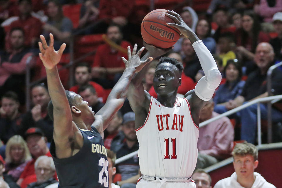 Utah guard Both Gach (11) shoots as Colorado guard McKinley Wright IV (25) defends in the second half during an NCAA college basketball game Saturday, March 7, 2020, in Salt Lake City. (AP Photo/Rick Bowmer)