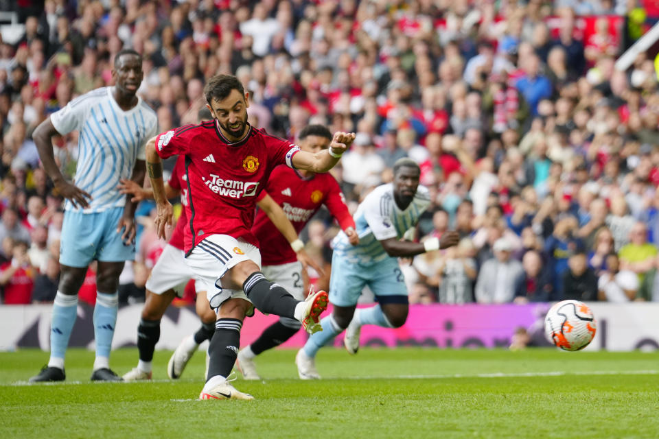 Manchester United's Bruno Fernandes scores on a penalty kick during the English Premier League soccer match between Manchester United and Nottingham Forest at the Old Trafford stadium in Manchester, England, Saturday, Aug. 26, 2023. (AP Photo/Jon Super)