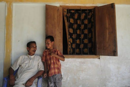 An elder of the Patra tribe speaks with a child in Daliopara, near Dhaka. Many languanges like the Laleng spoken by the Patra tribe in the country's far northeast are vulnerable, having no script and relying instead on a fragile oral tradition of folk songs and story telling