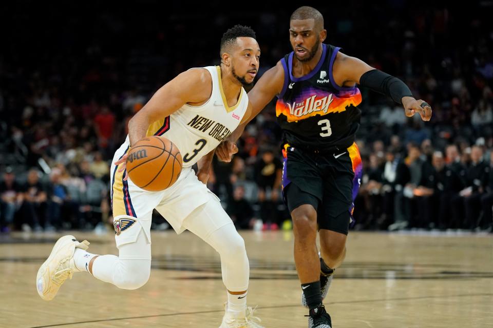 Pelicans guard CJ McCollum, left, drives as Suns guard Chris Paul defends during the second half of Game 5 of an NBA first-round playoff series, Tuesday, April 26, 2022, in Phoenix. (AP Photo/Matt York)