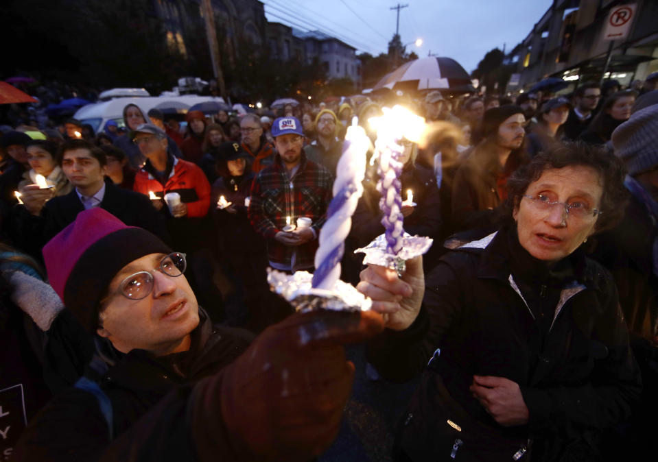 People light candles as they gather for a vigil in the aftermath of a deadly shooting at the Tree of Life synagogue in the Squirrel Hill neighborhood of Pittsburgh on Saturday. (Photo: Matt Rourke/AP)