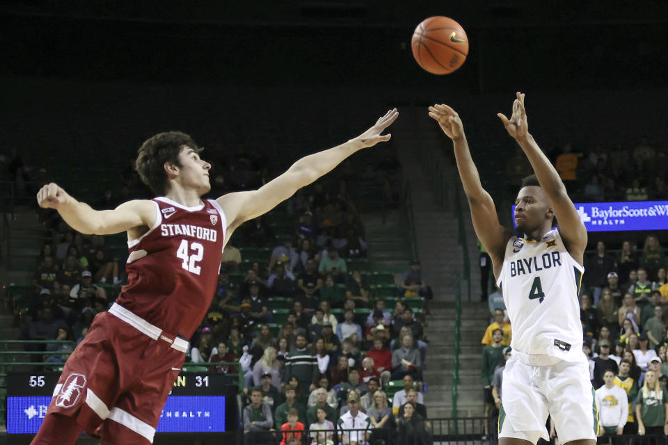 Baylor guard LJ Cryer shoots a 3-point shot over Stanford forward Maxime Raynaud in the second half of an NCAA college basketball game, Saturday, Nov. 20, 2021, in Waco, Texas. (AP Photo/Jerry Larson)