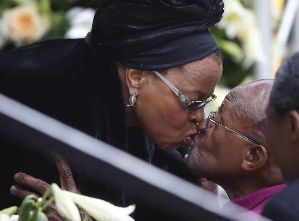 Graca Machel, Nelson Mandela's former, kisses Retired Anglican Archbishop Desmond Tutu during the memorial service for former South African president Nelson Mandela at the FNB Stadium in Soweto near Johannesburg, Tuesday, Dec. 10, 2013. (AP Photo/Matt Dunham)  <em> CORRECTION: An earlier version of this caption misidentified Graca Machel as Winnie Mandela. </em>