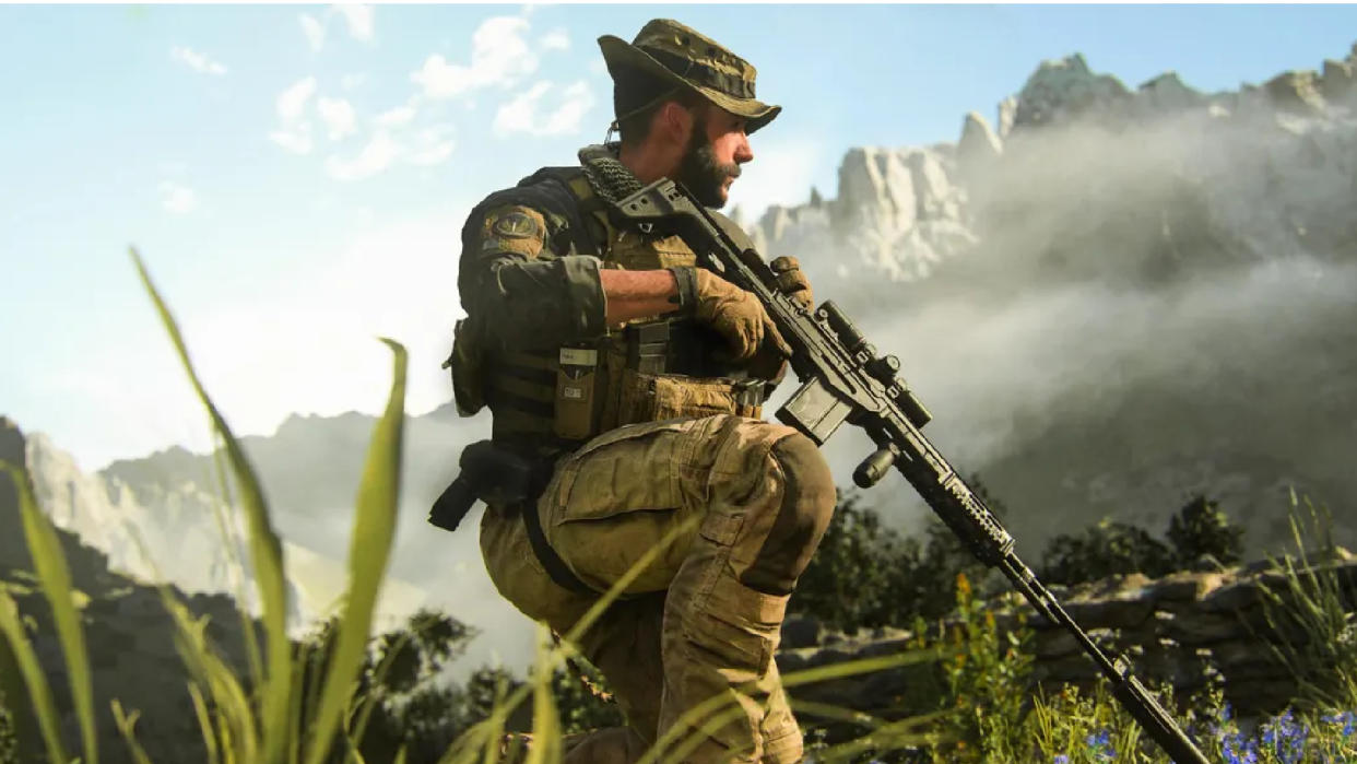  Captain Price kneeling in a grass field holding a sniper rifle. 