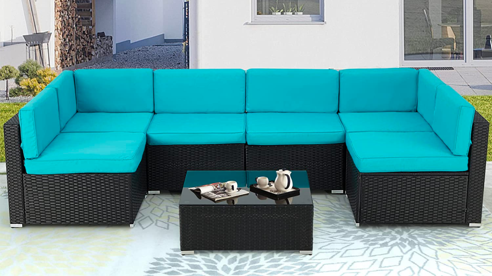 Add a pop of color with bright cushions to contrast to the dark wicker.