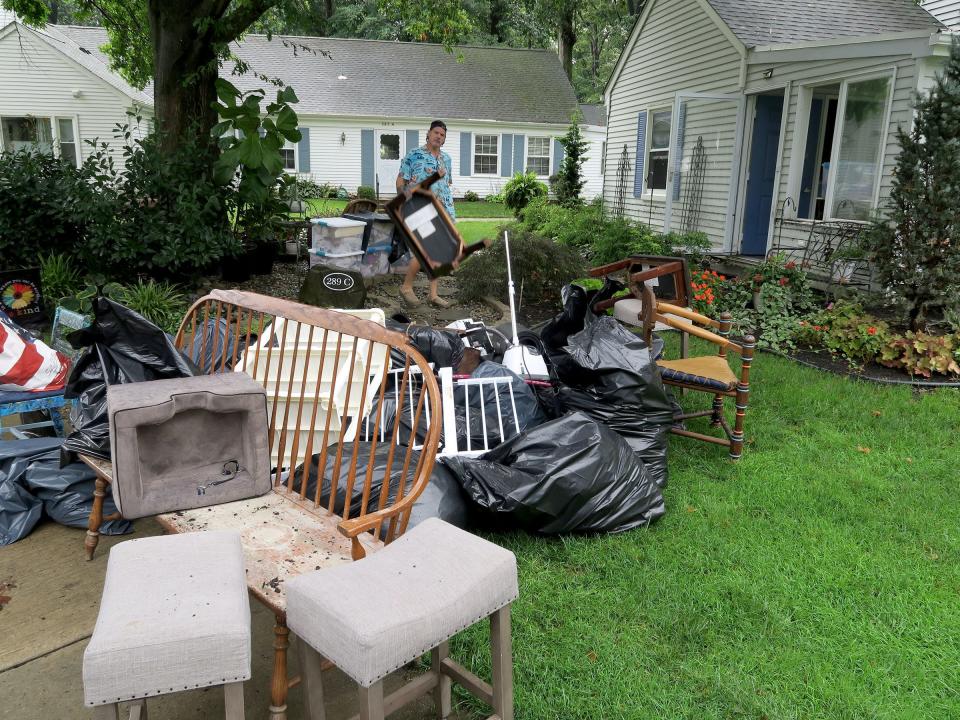 The pile of furniture and trash pulled from Loretta Moses' home on Sharon Way home in the Rossmoor community in Monroe Township builds Monday morning, August 23, 2021.  Her home was damaged by flooding over the weekend.