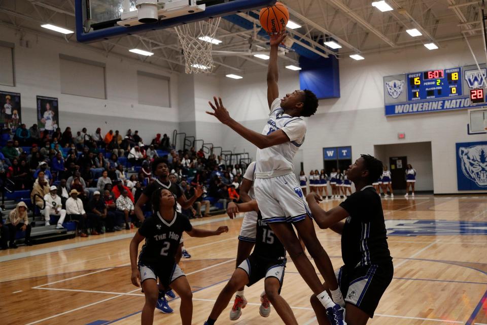 Woodville-Tompkins' Jonathon Pickering slices to the basket Friday during the Region 3A Div. 1 Title game against Savannah High.