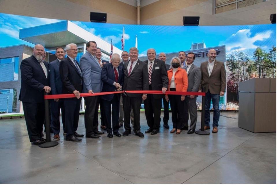 Ribbon cutting for the new emergency response training facility: Roane State Community College President Chris Whaley; from left, state Rep. John Ragan; Ashley Stowe, Oak Ridge Enhanced Training and Technology Center director;  Jim Palmer, Roane County Industrial Development Board chair; Oak Ridge City Manager Mark Watson; Roane County Executive Wade Creswell; state Sen. Ken Yager; state Rep. Monty Fritts; Lt. Gov. Randy McNally; Oak Ridge Mayor Warren Gooch; Rich Tighe, Consolidated Nuclear Security president and CEO; Teresa Robbins, National Nuclear Security Administration Production Office manager; former state Rep., Kent Calfee; Art Atkins, NNSA assistant deputy administrator of Global Material Security, Oak Ridge City Council member Jim Dodson.