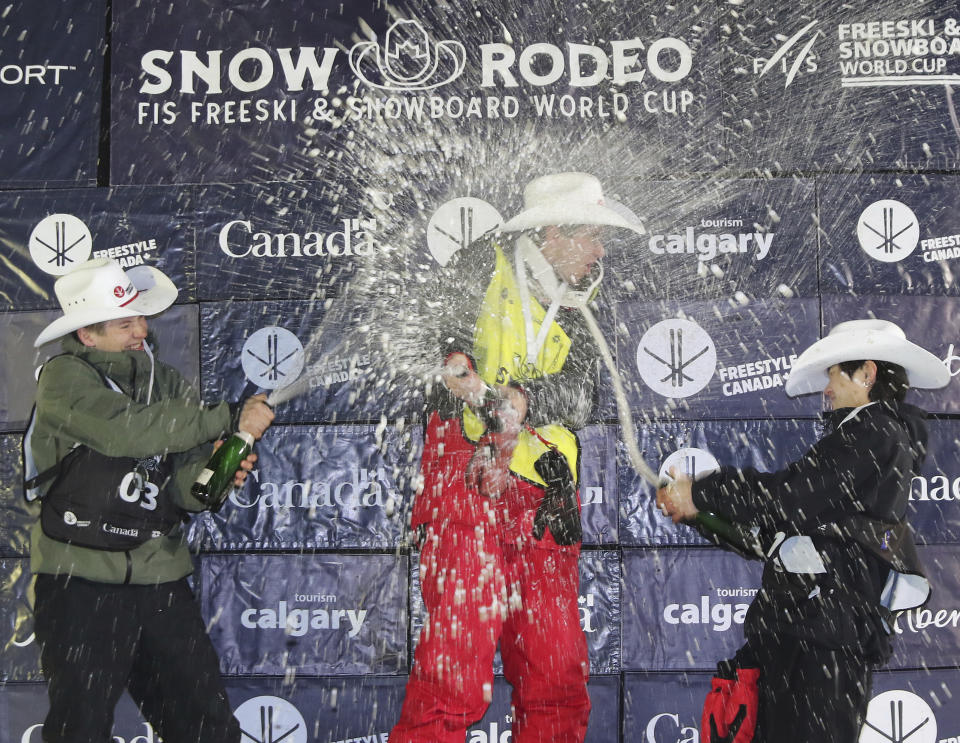 FILE - United States' Alex Ferreira, center, who won, celebrates on the podium with second-place Jon Sallinen, left, of Finland, and third-place Lee Seung-hun, of South Korea, in the men's FIS World Cup freeski halfpipe final Saturday, Feb. 17, 2024, in Calgary, Alberta. Ferreira won every contest in the halfpipe this season. (Dave Chidley/The Canadian Press via AP, File)