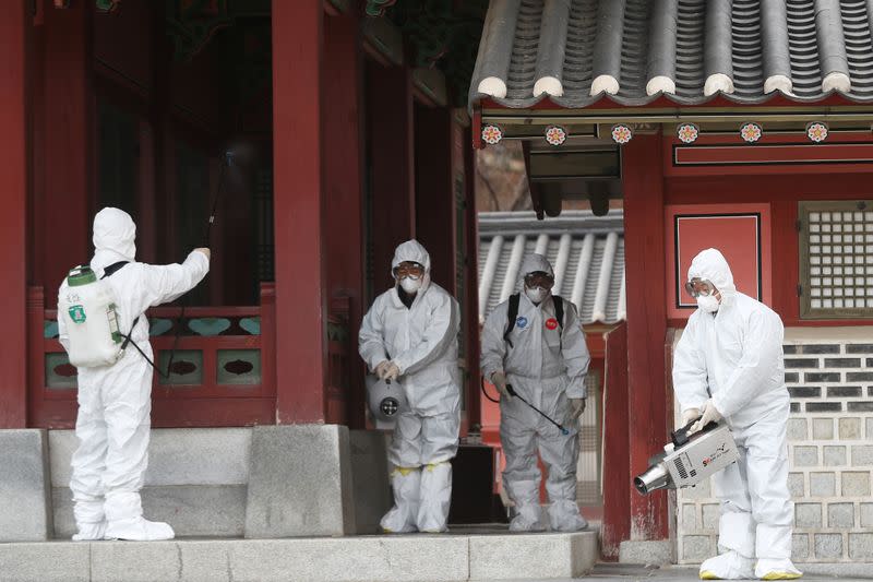 Officials from a public health center sanitize a traditional palace in Suwon