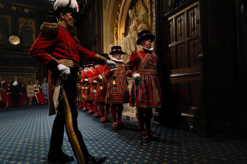 Yeomen Warders perform the ceremonial search of the Palace of Westminster prior to the State Opening of Parliament in London, Tuesday, May 10, 2022. Buckingham Palace said Queen Elizabeth II will not attend the opening of Parliament on Tuesday amid ongoing mobility issues. (AP Photo/Alastair Grant, Pool)