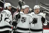 Los Angeles Kings center Jaret Anderson-Dolan, middle, celebrates his goal against the Arizona Coyotes with teammates, including defensemen Drew Doughty (8) and Mikey Anderson (44), during the first period of an NHL hockey game Wednesday, May 5, 2021, in Glendale, Ariz. (AP Photo/Ross D. Franklin)